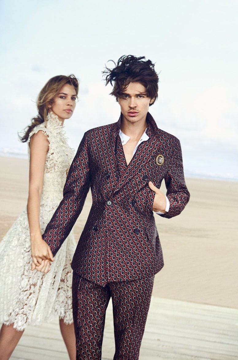 Will Peltz and Kenya Kiski Jones posing wearing coat pant and Gown